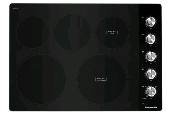 Tope KitchenAid con superficie vitrocerámica negra, cinco zonas de cocción eléctricas y controles giratorios laterales. Diseño moderno y elegante ideal para cocinas contemporáneas y espacios integrados.