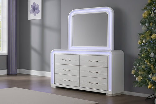 Gavetero con espejo blanco con luces LED y con seis gavetas en un entorno de habitación moderno. 