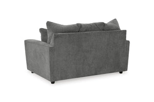 Vista posterior de loveseat gris con cojines decorativos sobre fondo blanco.