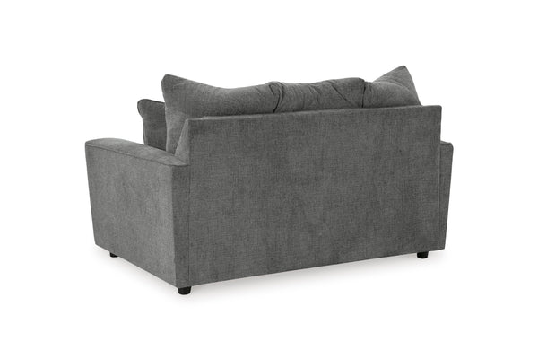 Vista posterior de loveseat gris con cojines decorativos sobre fondo blanco.