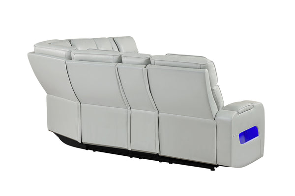 Vista posterior y lateral de sofá seccional reclinable en color gris claro con tapizado liso, respaldos altos acolchados y detalle de iluminación LED azul integrada en el brazo lateral. Diseño modular con acabados modernos y líneas limpias.