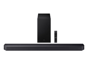 Barra de sonido negra con control remoto sobre fondo blanco. 