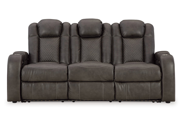 Sofá reclinable eléctrico con cabecera y reposapiés ajustables, integrado con luz LED, con portavasos y de color marrón oscuro, en un fondo blanco. 