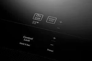 Primer plano de un panel de control electrónico negro con etiquetas de texto blancas que incluyen 'Encendido/Apagado', 'Tamaño de zona', 'Bloqueo de control' y 'Temporizador', mostrando los botones de más y menos.