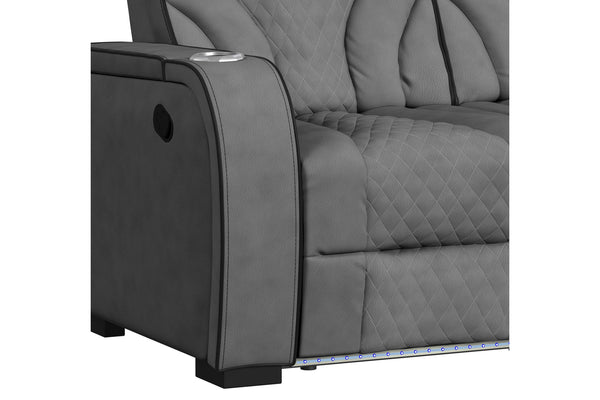 Detalle lateral de sofá reclinable gris oscuro con tapizado acolchado de patrón romboidal, apoyabrazos amplio con portavasos integrado y mecanismo de reclinación lateral. Incluye iluminación LED decorativa en la base para un estilo contemporáneo.