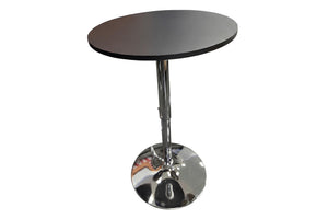 Una moderna mesa de bar redonda con tablero negro y base de pedestal cromada con reposapiés circular, aislada sobre un fondo blanco.