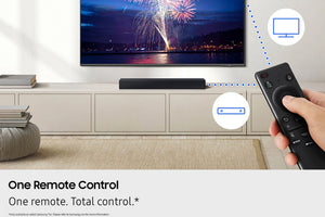 Configuración de sala de estar con TV, barra de sonido y control remoto, con exhibición de fuegos artificiales en pantalla.