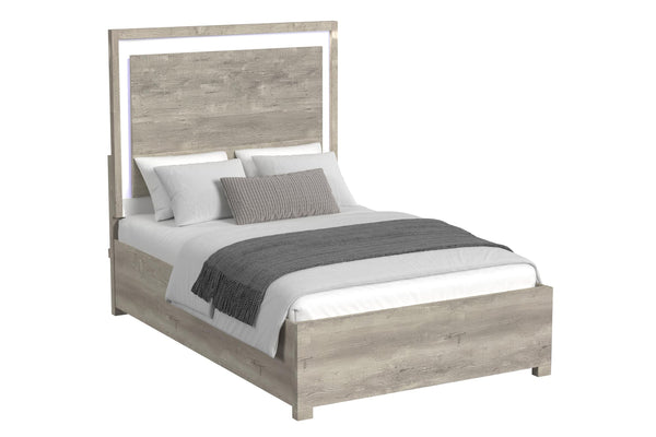 Cama de color gris claro y blanco con acolchado sobre un fondo blanco. 