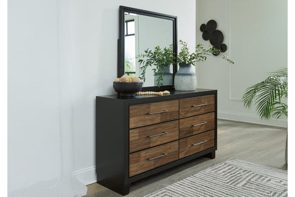 Gavetero con espejo y elementos decorativos en un ambiente de habitación.