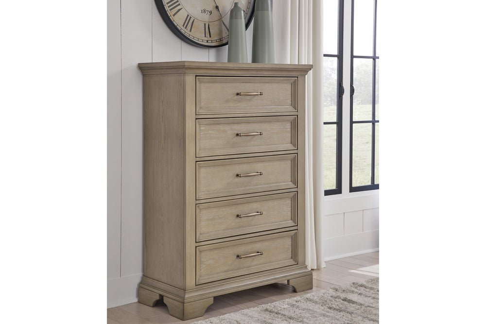 Rustic wooden dresser consisting of five drawers with light bronze handles on a white background. 