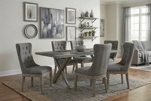 Juego de comedor con mesa de madera y sillas de tela y madera grises con espaldar ancho en una habitación bien iluminada.