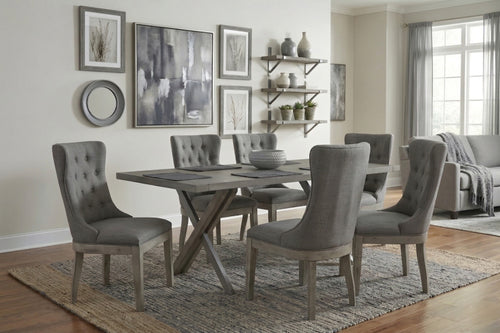 Juego de comedor con mesa de madera y sillas de tela y madera grises con espaldar ancho en una habitación bien iluminada.