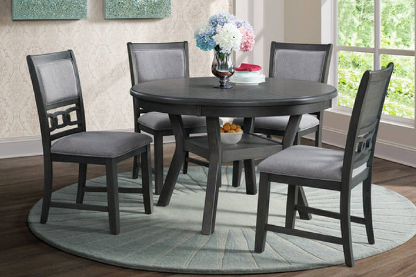Conjunto de comedor con mesa redonda gris y cuatro sillas sobre alfombra.