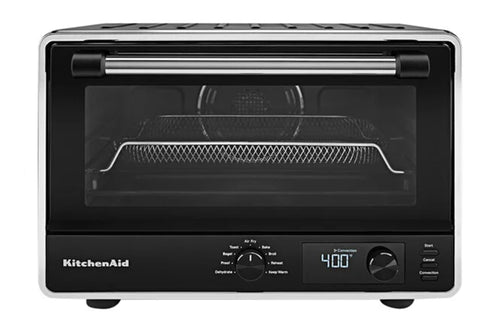 Horno de sobremesa KitchenAid con puerta de cristal negro, exterior de metal plateado y panel de control digital en la parte frontal.
