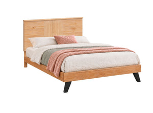 Cama de plataforma moderna con cabezal y pie de cama en madera de roble claro, decorada con ropa de cama neutra, un cojín rosado y una manta en tonos rosado y verde salvia, presentada sobre un fondo blanco sólido.