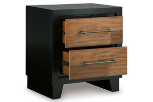 Mesa de noche bicolor con acabado en negro y madera con dos gavetas abiertas sobre fondo blanco.