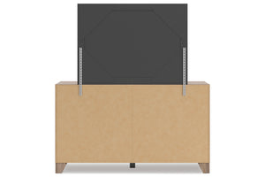 Un mueble de almacenamiento de con un panel gris carbón oscuro levantado sobre él, sobre un fondo blanco sencillo.