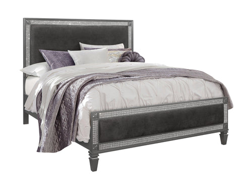 Jeweled, dark grey bed with purple and white bedding on a white background. 