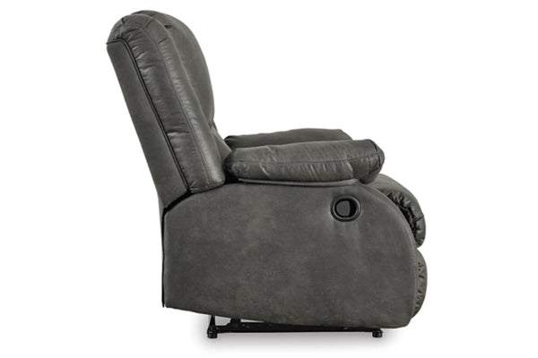 Vista lateral de butaca reclinable de gris sobre un fondo blanco. 