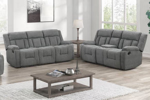 Conjunto de sofá y loveseat reclinable manual gris en una sala de estar con una mesa de centro de madera.