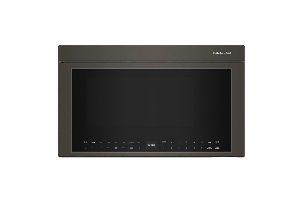 Horno microondas empotrable con acabado gris carbón oscuro, visto de frente sobre un fondo blanco liso. La marca «KitchenAid» es visible en la esquina superior derecha del marco de la puerta.