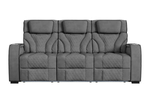 Sofá reclinable de tres plazas en color gris oscuro, con respaldo alto, cabeceras acolchadas, tapizado con patrón acolchado tipo rombos y apoyabrazos amplios. Diseño contemporáneo con iluminación LED integrada en la base frontal.