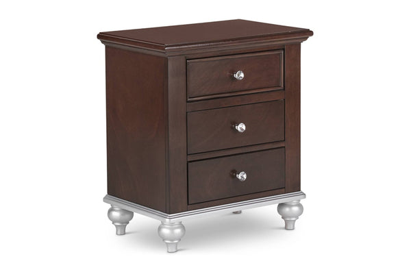 Mesa de noche marrón oscuro con tres gavetas y con manijas brillantes sobre un fondo blanco. 