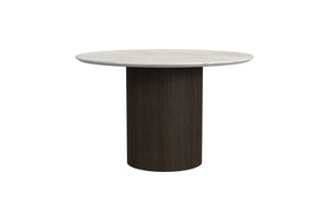 Mesa de comedor redonda con tablero blanco y base cilíndrica marrón oscuro sobre fondo blanco.