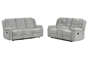 Conjunto de sofás y loveseat con consola reclinables grises sobre fondo blanco.