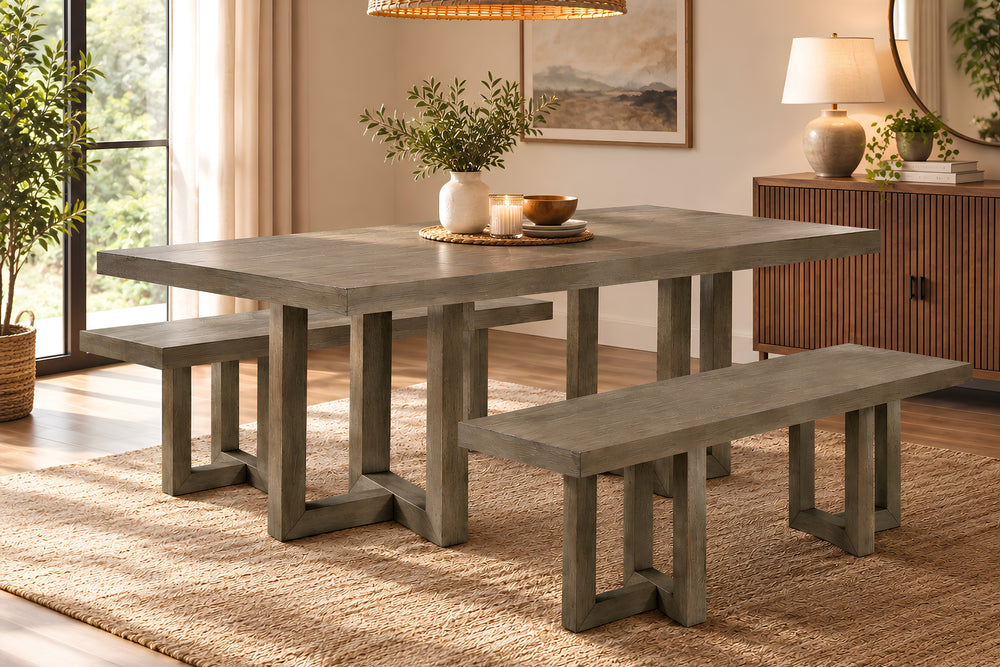Una mesa de comedor rústica con acabado de hormigón gris y bancos a juego en fondo blanco
