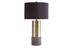 Lámpara de mesa con pantalla negra, sección central dorada y base gris sobre fondo blanco.