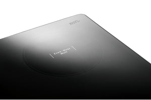 Primer plano de una superficie negra texturizada con un área circular hundida y un pequeño texto blanco que dice "EVERY HEAT Melt" y "SPEECHLESS" sobre un fondo blanco.